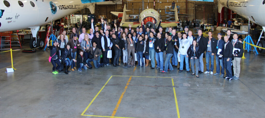 XPRIZE ADVENTURE + INNOVATION EXPERIENCE attendees explore Scaled Composite's facilities group photo